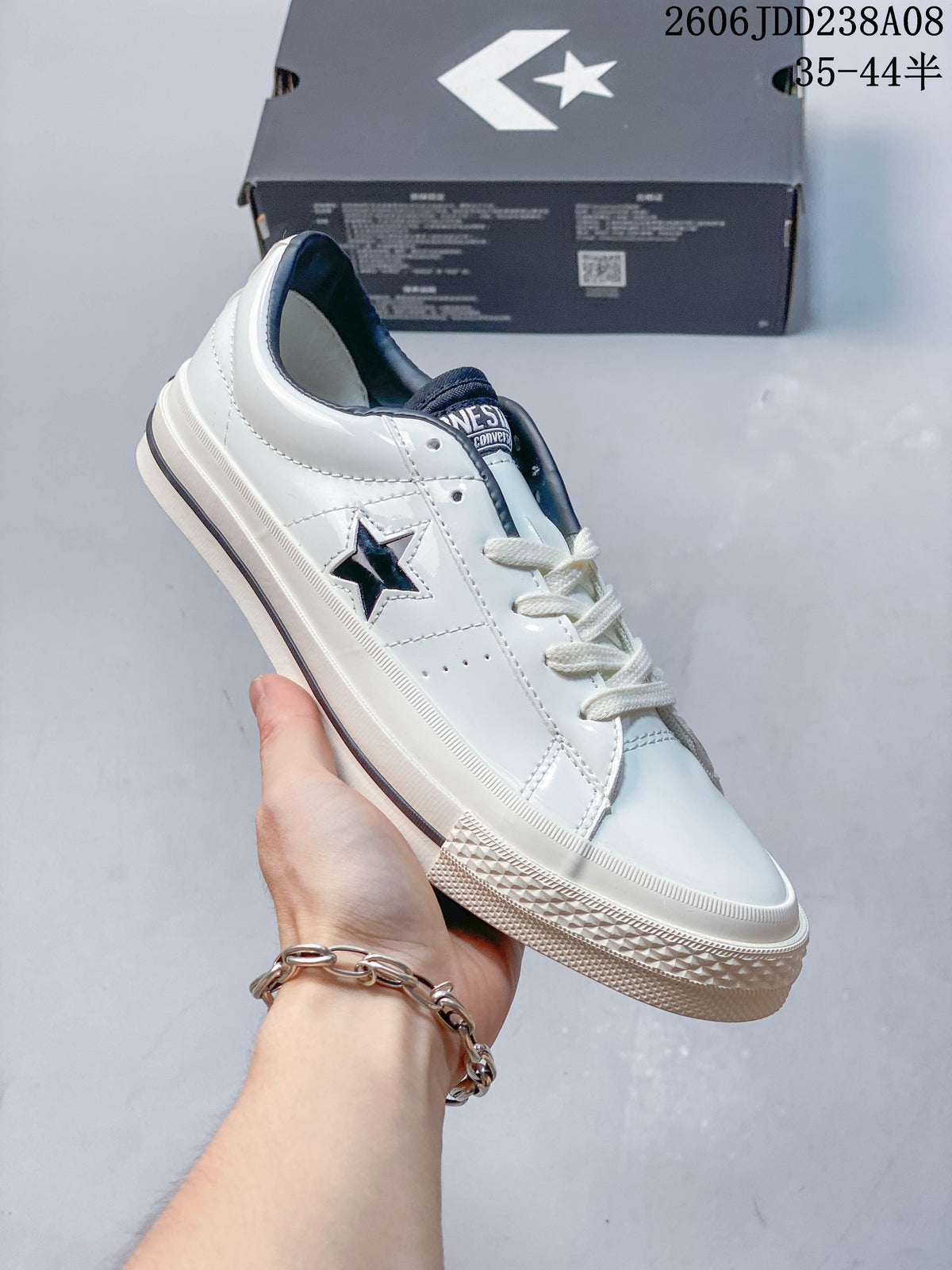 Angled view of a white Converse One Star low-top sneaker