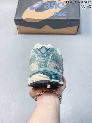 Rear view of the light sage ASICS sneaker showing the layered heel construction and contrasting sole.