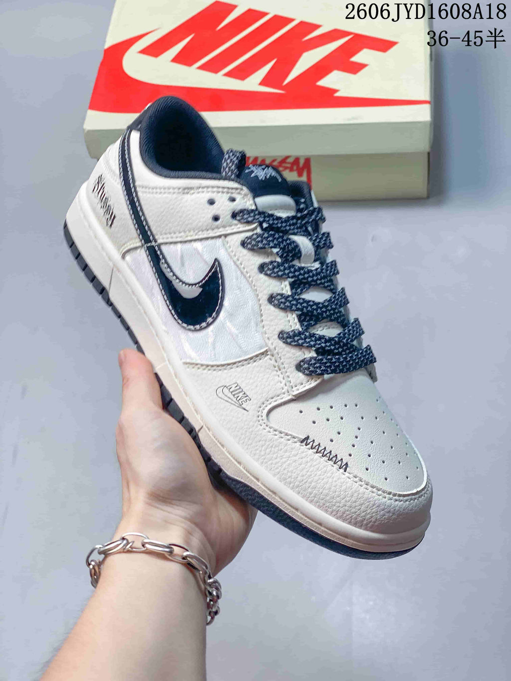 Angled view of the white and navy low-top sneaker