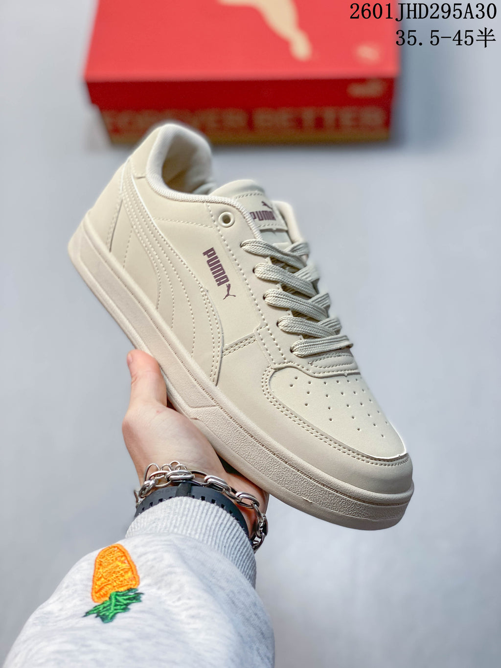 Angled view of a cream Puma Caven 2.0 sneaker with stitched side detailing
