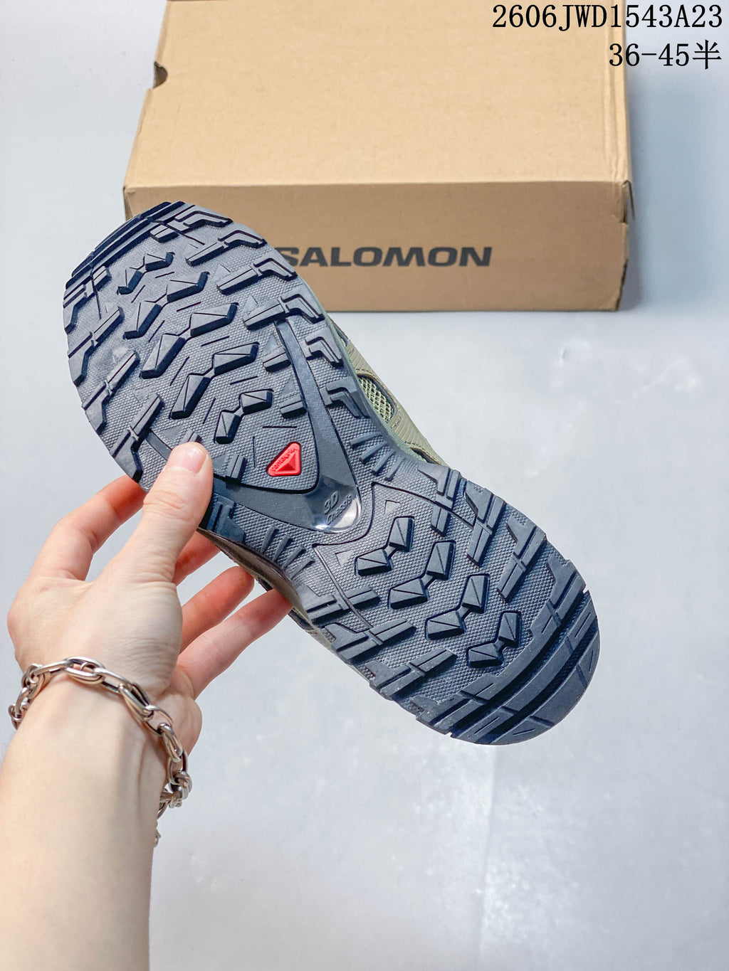 Close view of the shoe outsole showing pronounced tread lugs