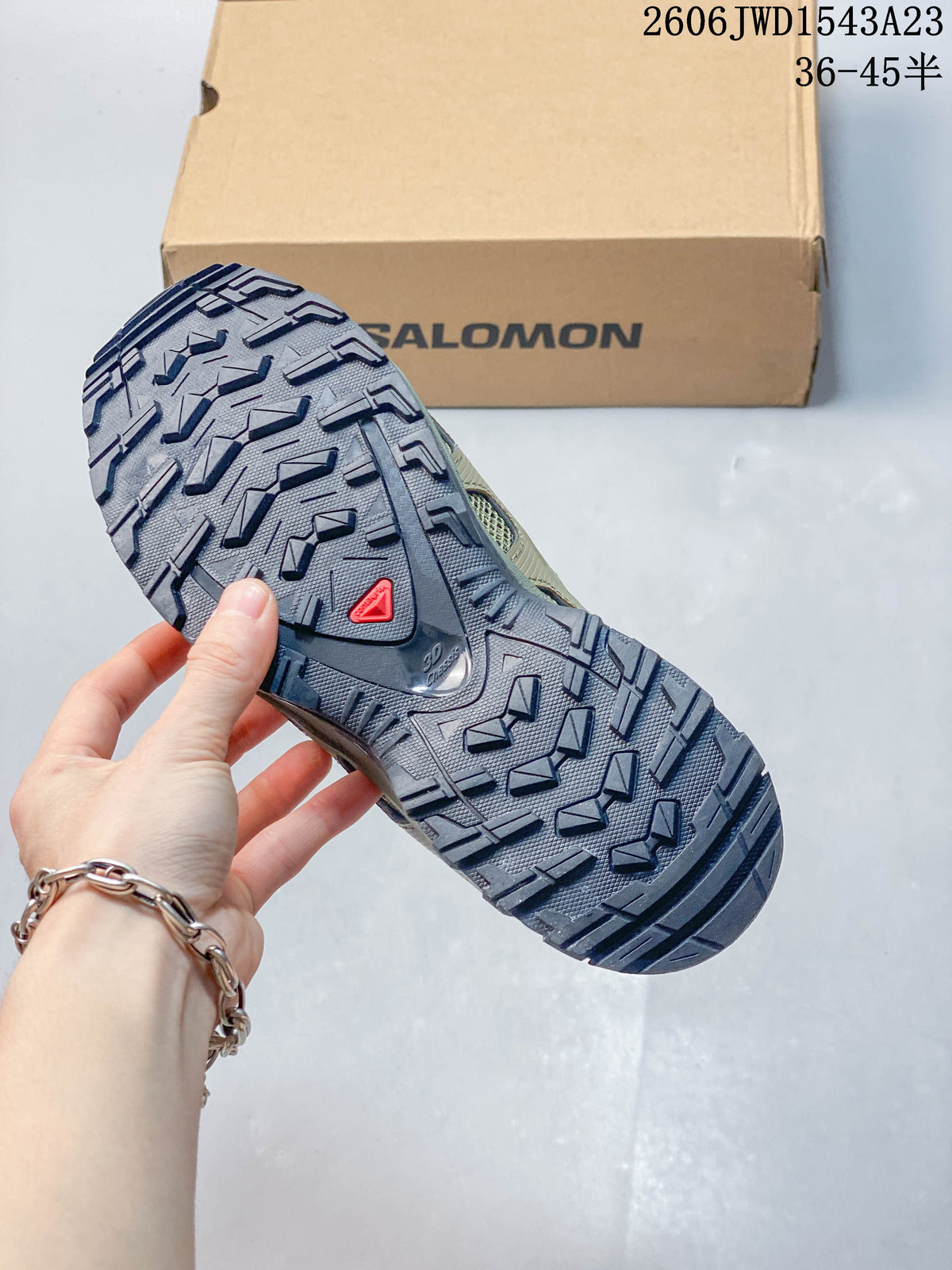 Close view of the shoe outsole showing pronounced tread lugs