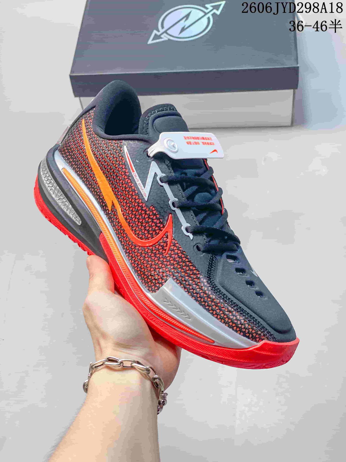 Dark gray Nike Air Zoom GT Cut low-top shoe with red accents and a bright red outsole.