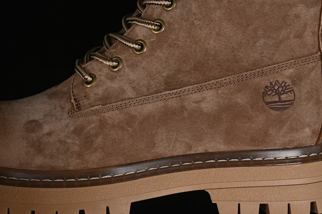 Close-up of the boot side, stitching, and tree logo