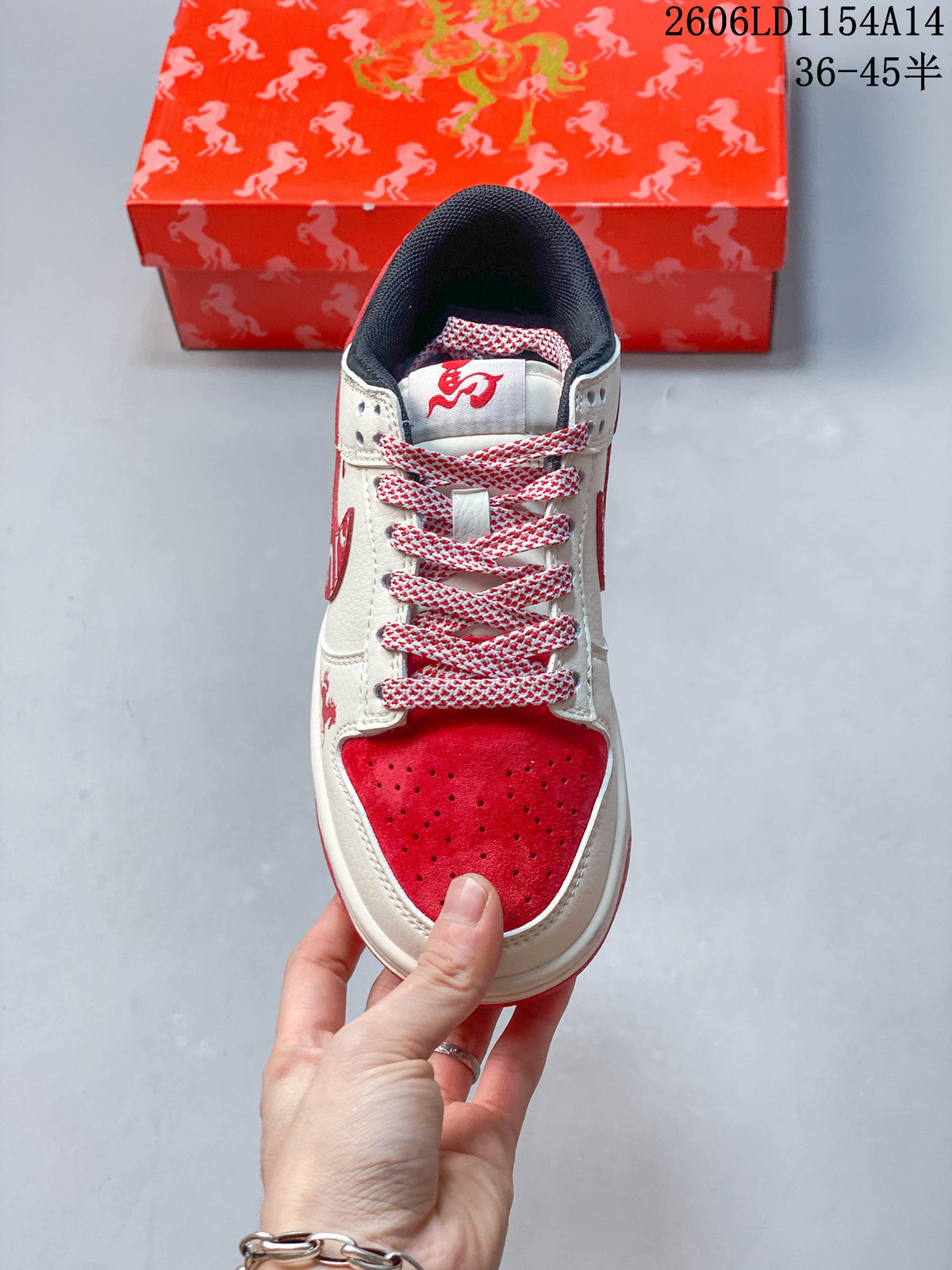 Top view showing the perforated red toe, patterned laces, and cream upper
