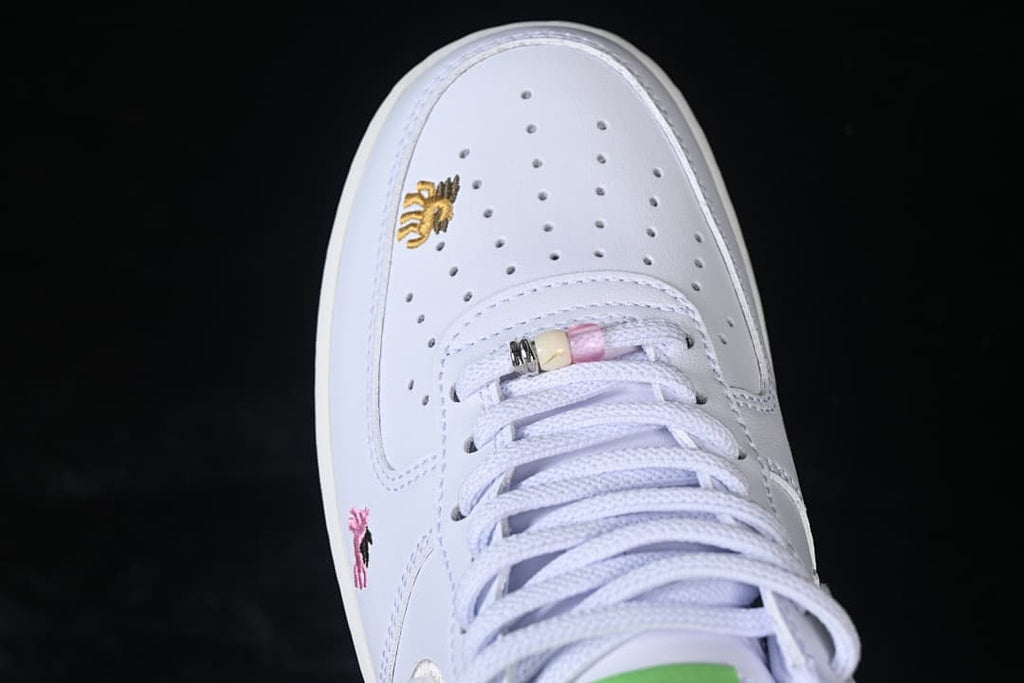 Top view of the perforated toe, laces, and small embroidered motif.