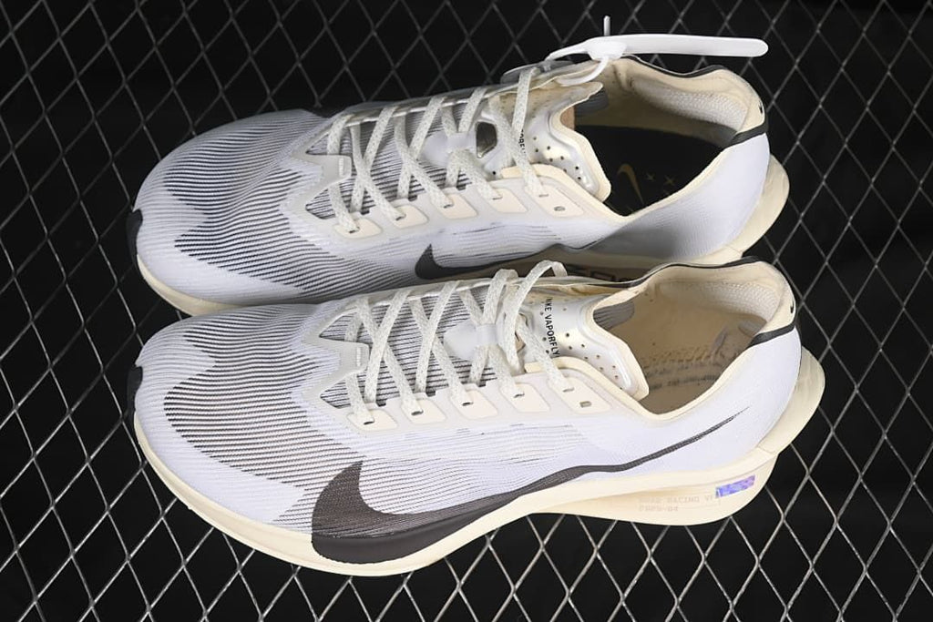 Pair of white and dark-accented running shoes shown from above and the side