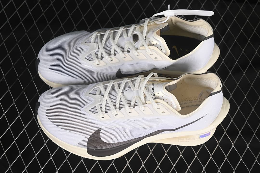 Pair of white and dark-accented running shoes shown from above and the side
