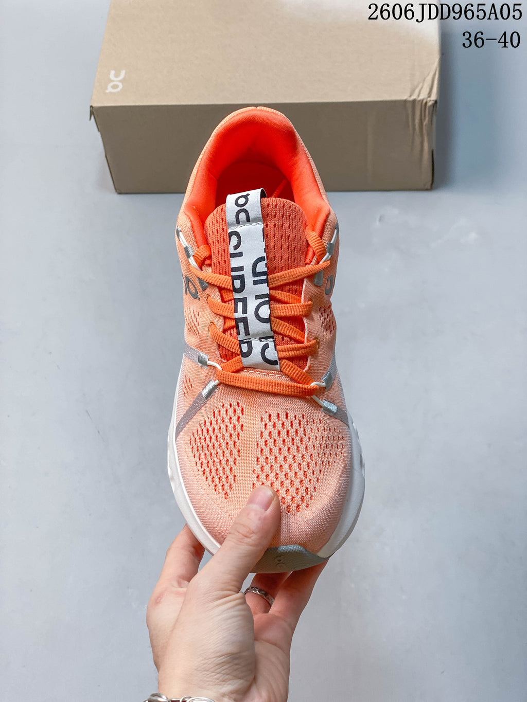 Top view of the coral knit shoe with orange laces