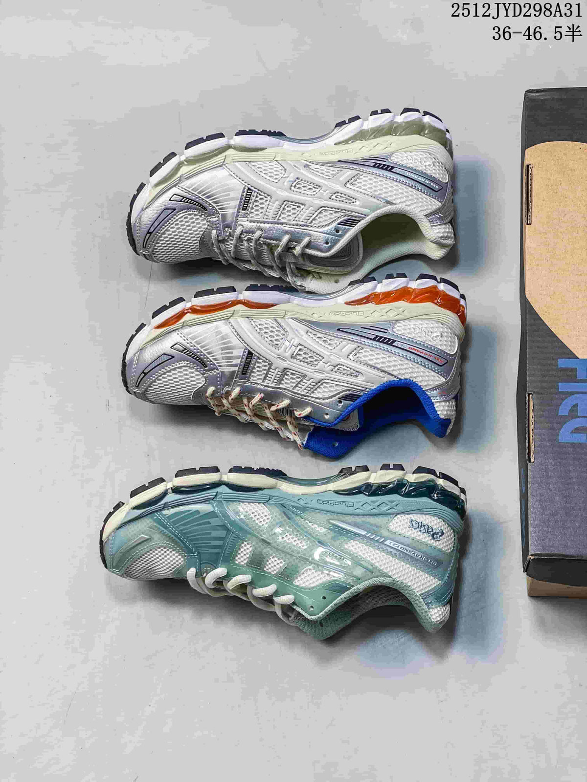 Three running sneakers displayed from the side, showing silver, white and aqua color variations.