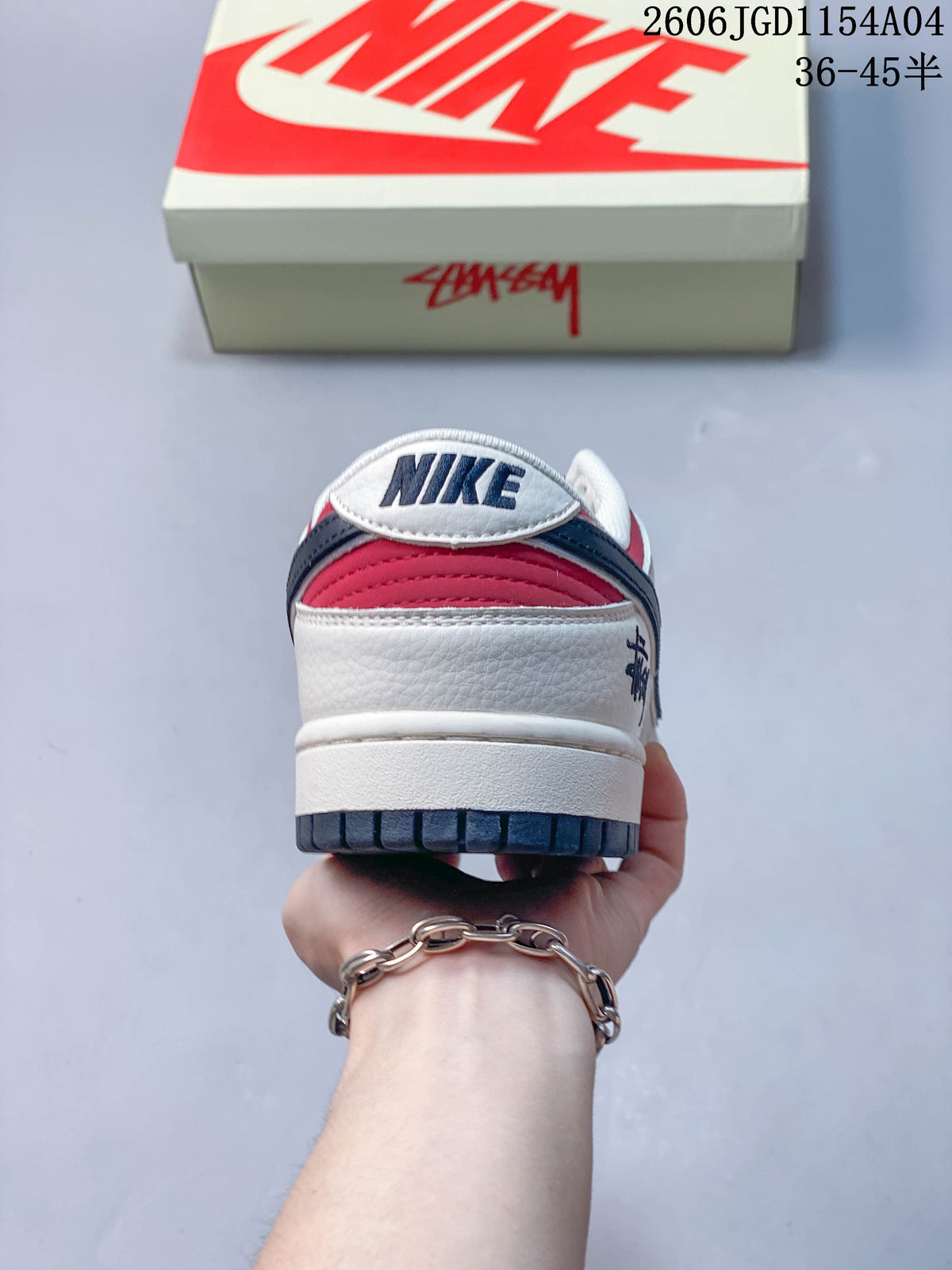 Rear view of a Nike SB Dunk Low sneaker showing red and navy heel details.