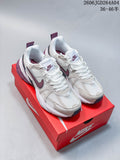 Pair of white Nike V2K Run sneakers with gray and plum accents on a red box