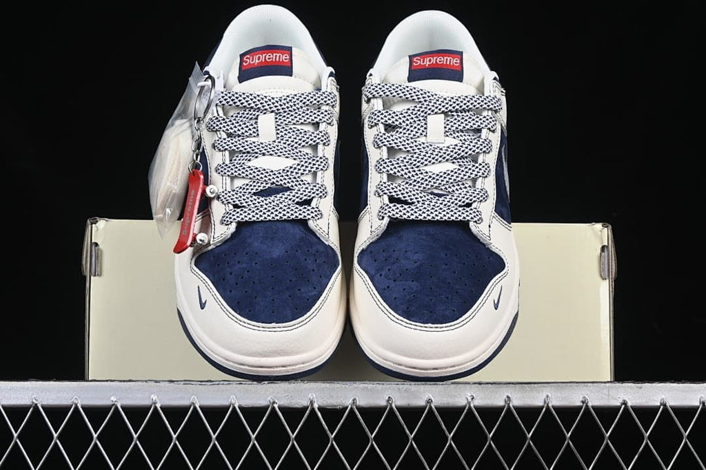 Front view of the pair showing navy toe panels, off-white uppers, and patterned laces.
