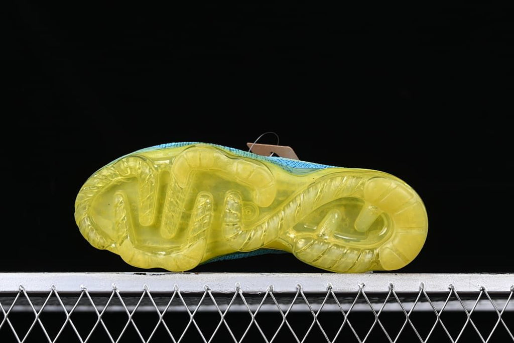 Underside view of the shoe with a translucent yellow sole.