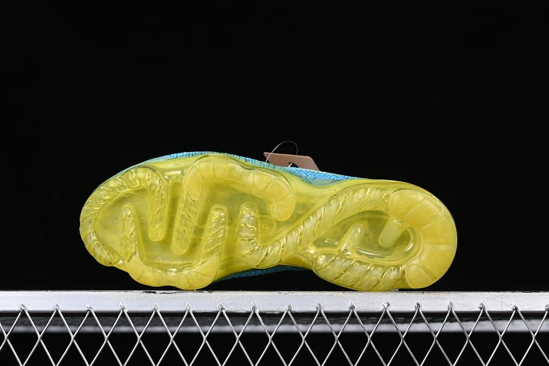 Underside view of the shoe with a translucent yellow sole.