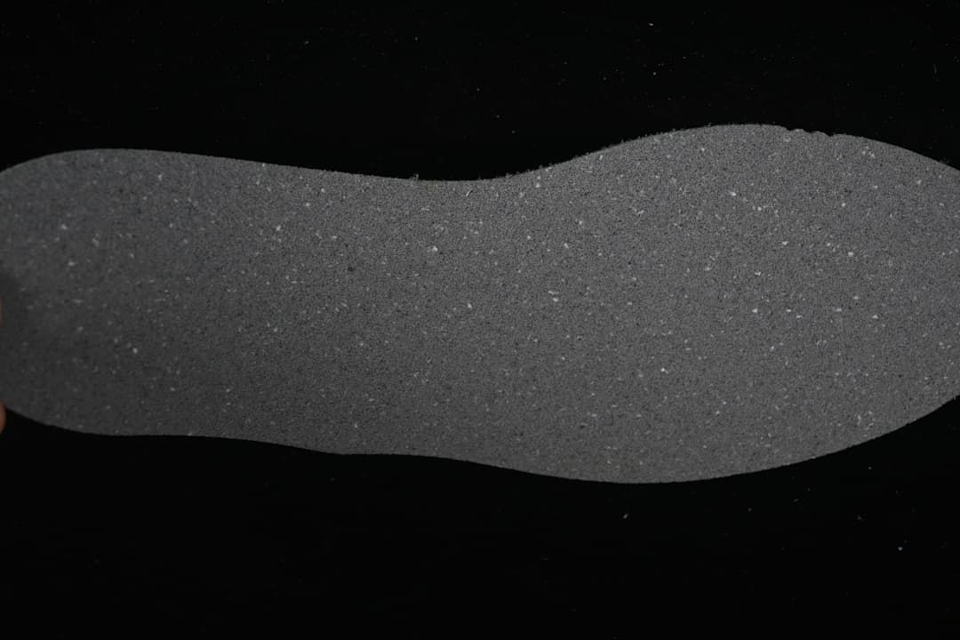 Close-up view of the shoe's dark gray textured outsole.