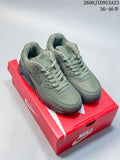 Pair of olive green Nike Air Max 90 sneakers on a red Nike shoe box