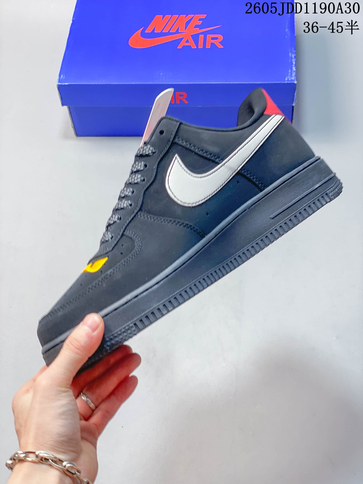 Side profile of the low-top sneaker with white Swoosh and dark gray sole.