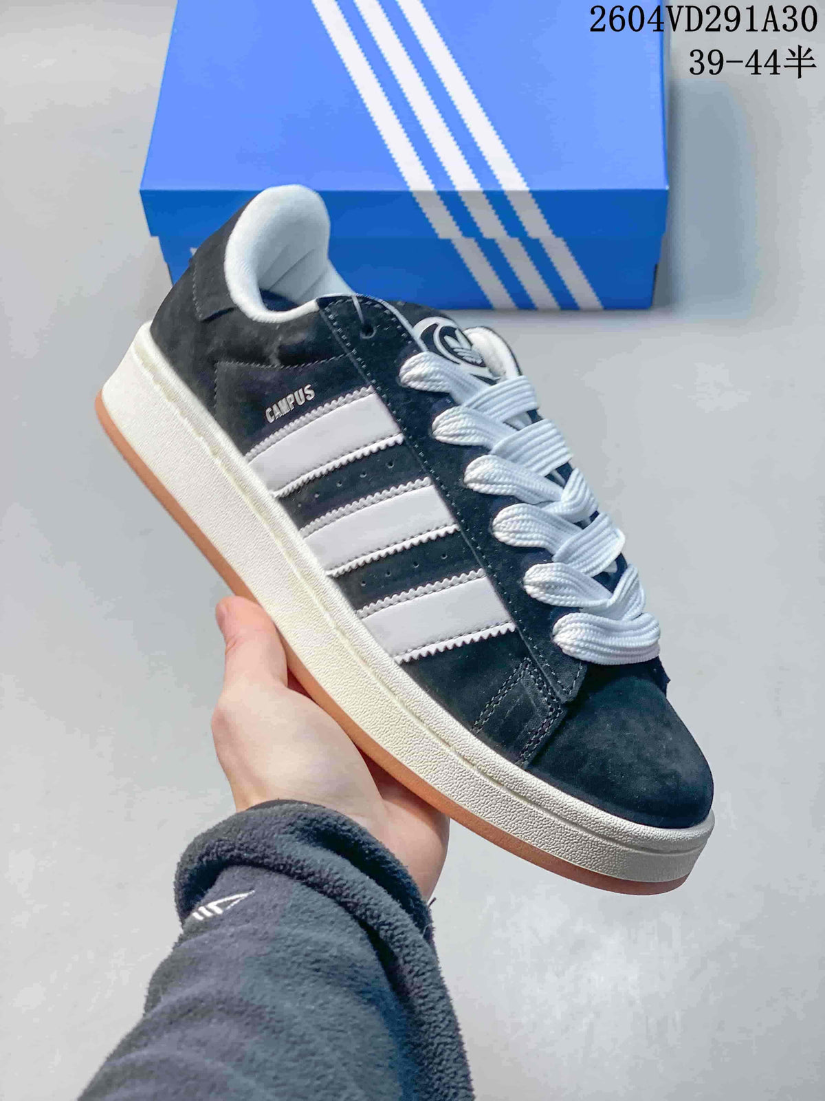 Angled side view showing Campus lettering, three-stripe details, white laces and a gum outsole