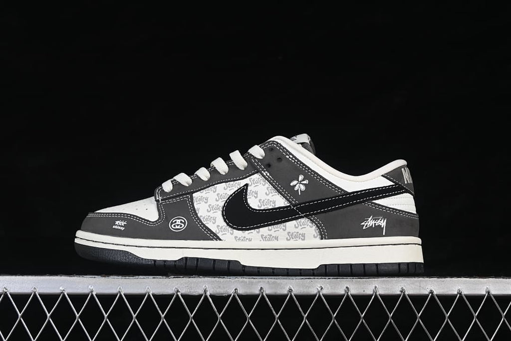 Side view of a white and grey low-top sneaker with a black Swoosh and patterned panels