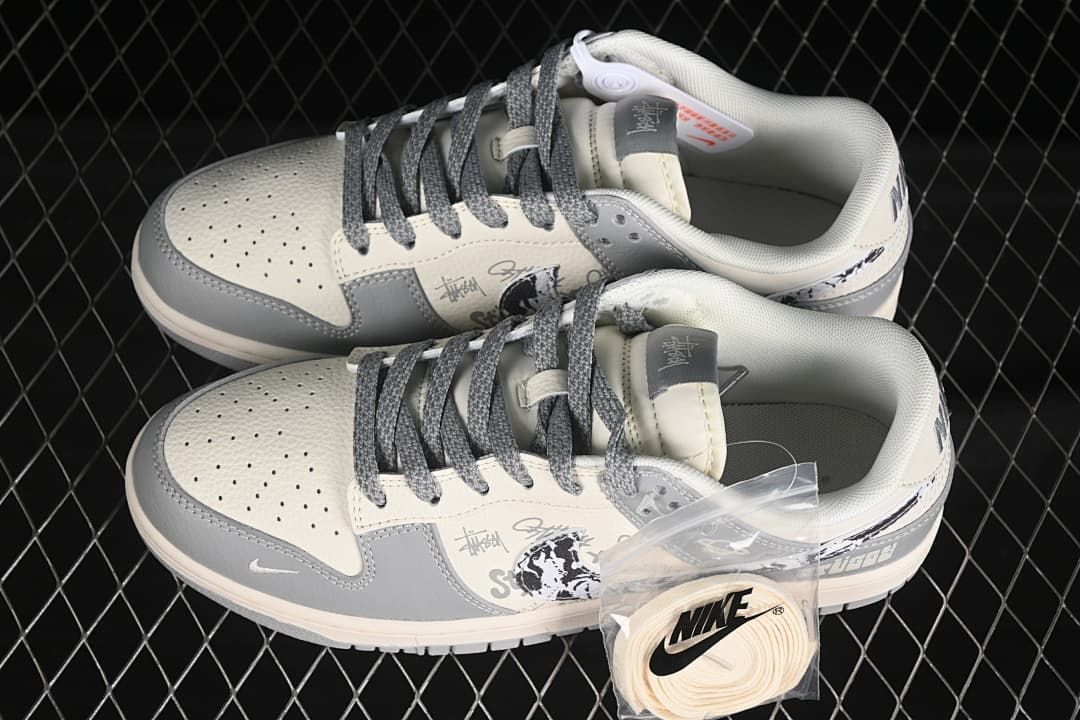Pair of gray and off-white low-top sneakers shown from above, with gray laces and an additional off-white lace set.