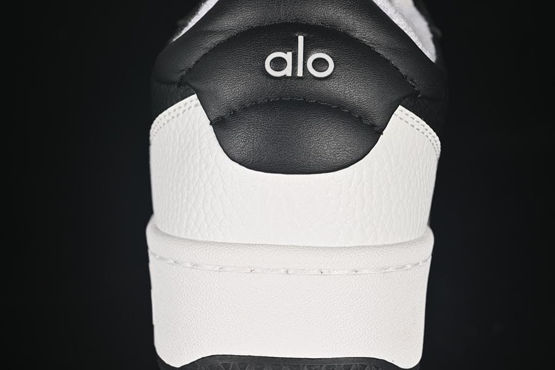 Rear view showing the black heel tab, Alo logo, and contrasting panels