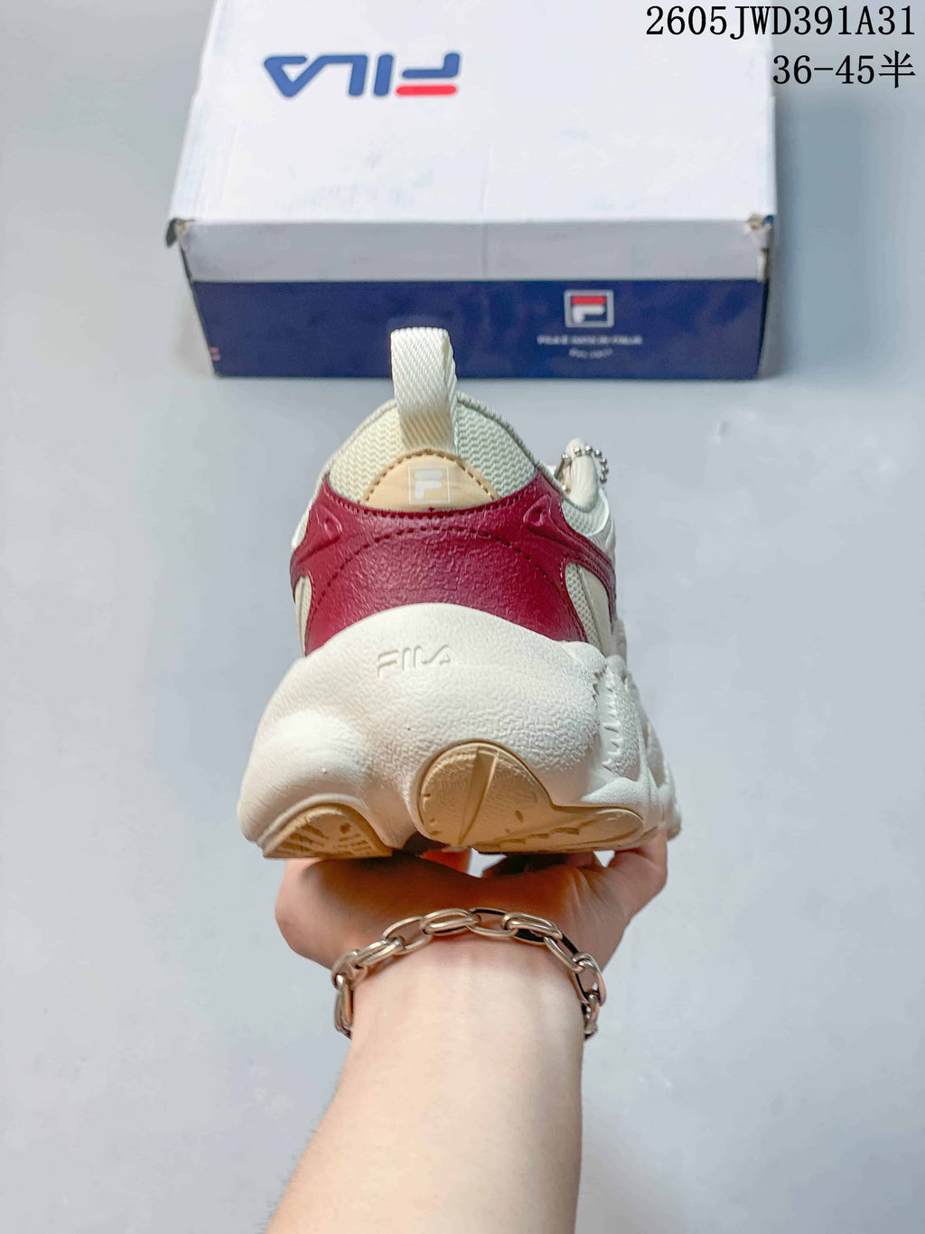 Rear view showing the burgundy heel panel and sculpted sole of the FILA sneaker