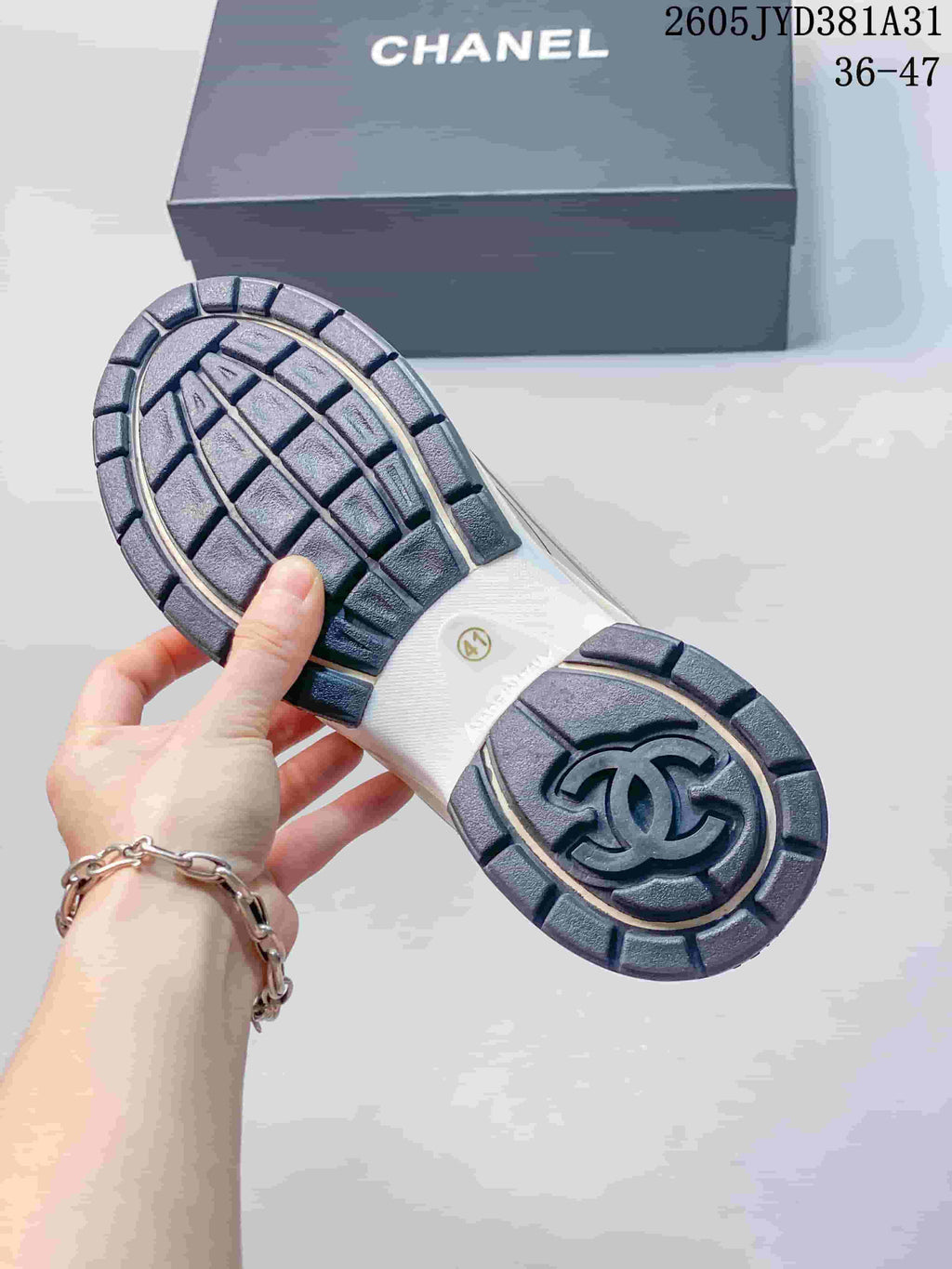 Close-up of the sneaker outsole with segmented tread and logo detail