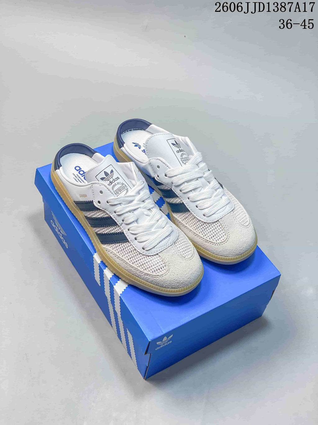 Pair of white Adidas Samba OG Mule sneakers with navy stripes and gum-colored soles