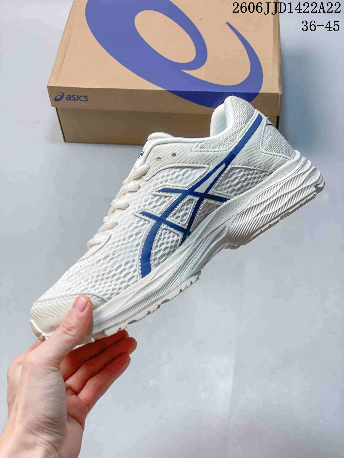 Side view of a white ASICS GEL-FLUX shoe with blue logo details