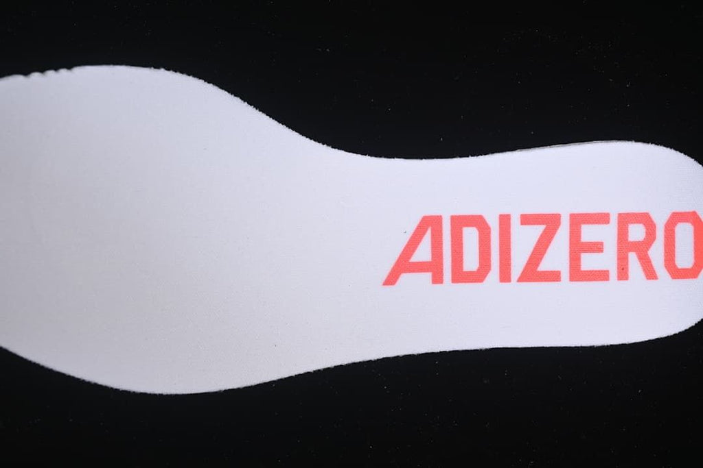 White shoe insert with Adizero branding.