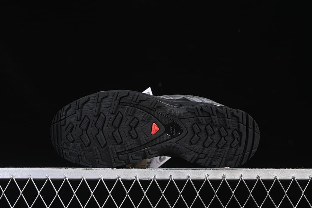 Underside view showing the black lugged outsole and a red accent.
