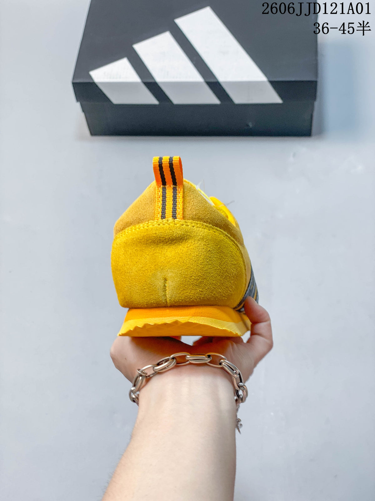 Rear view of the yellow sneaker with a striped heel pull tab