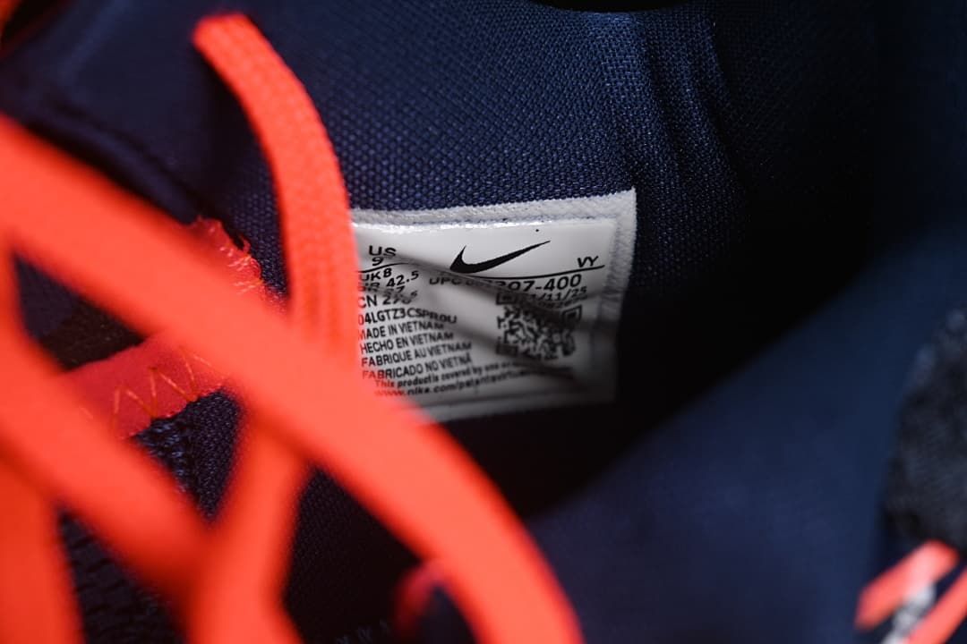 Interior size label photographed behind coral laces.