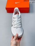 Top view of a white Nike Air Zoom Pegasus 42 shoe held in front of an orange shoe box.