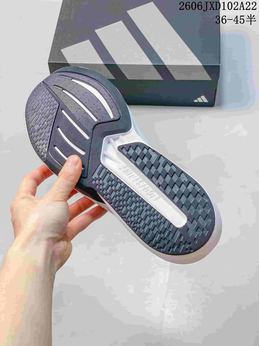Close-up of the dark patterned outsole and white midsole