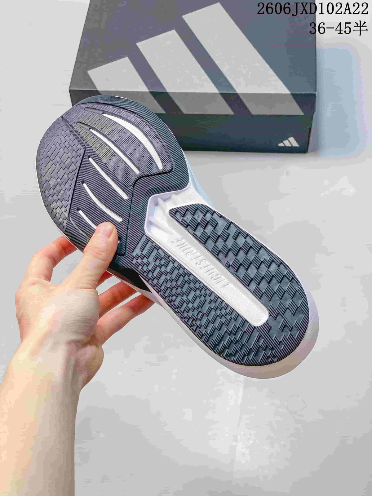 Close-up of the dark patterned outsole and white midsole