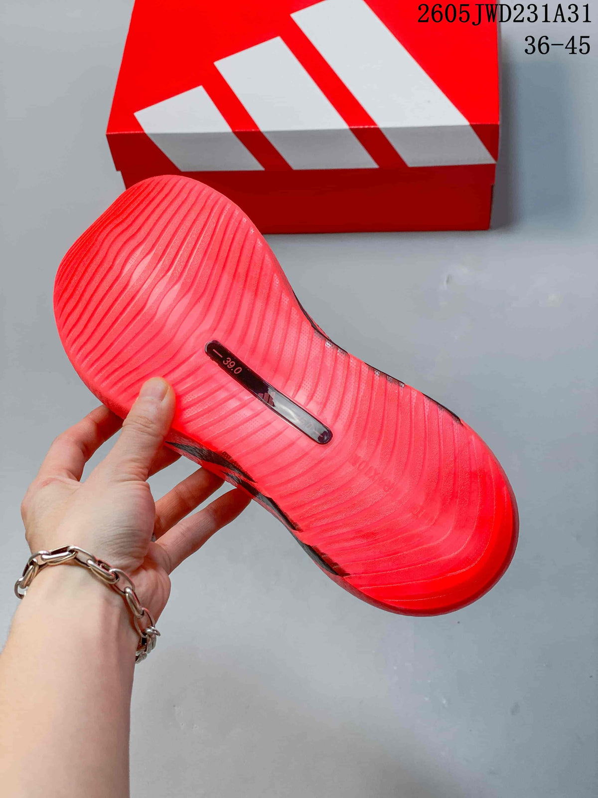 Underside of a bright pink shoe showing a ridged outsole and a visible size marking of 39.0.
