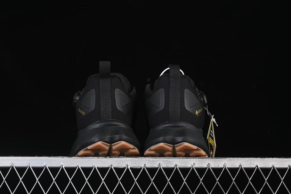 Rear view of both shoes showing heel pull tabs and tan-toned outsole lugs.