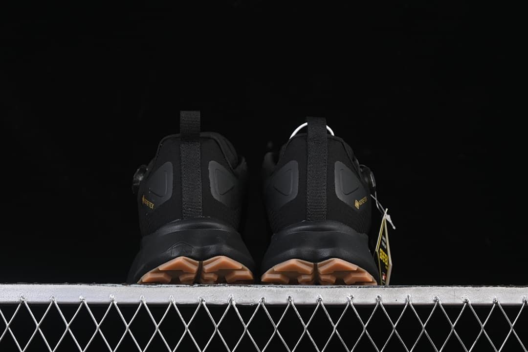 Rear view of both shoes showing heel pull tabs and tan-toned outsole lugs.