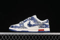 Side view of a blue-and-white patterned Nike SB Dunk Low sneaker with white midsole and blue outsole