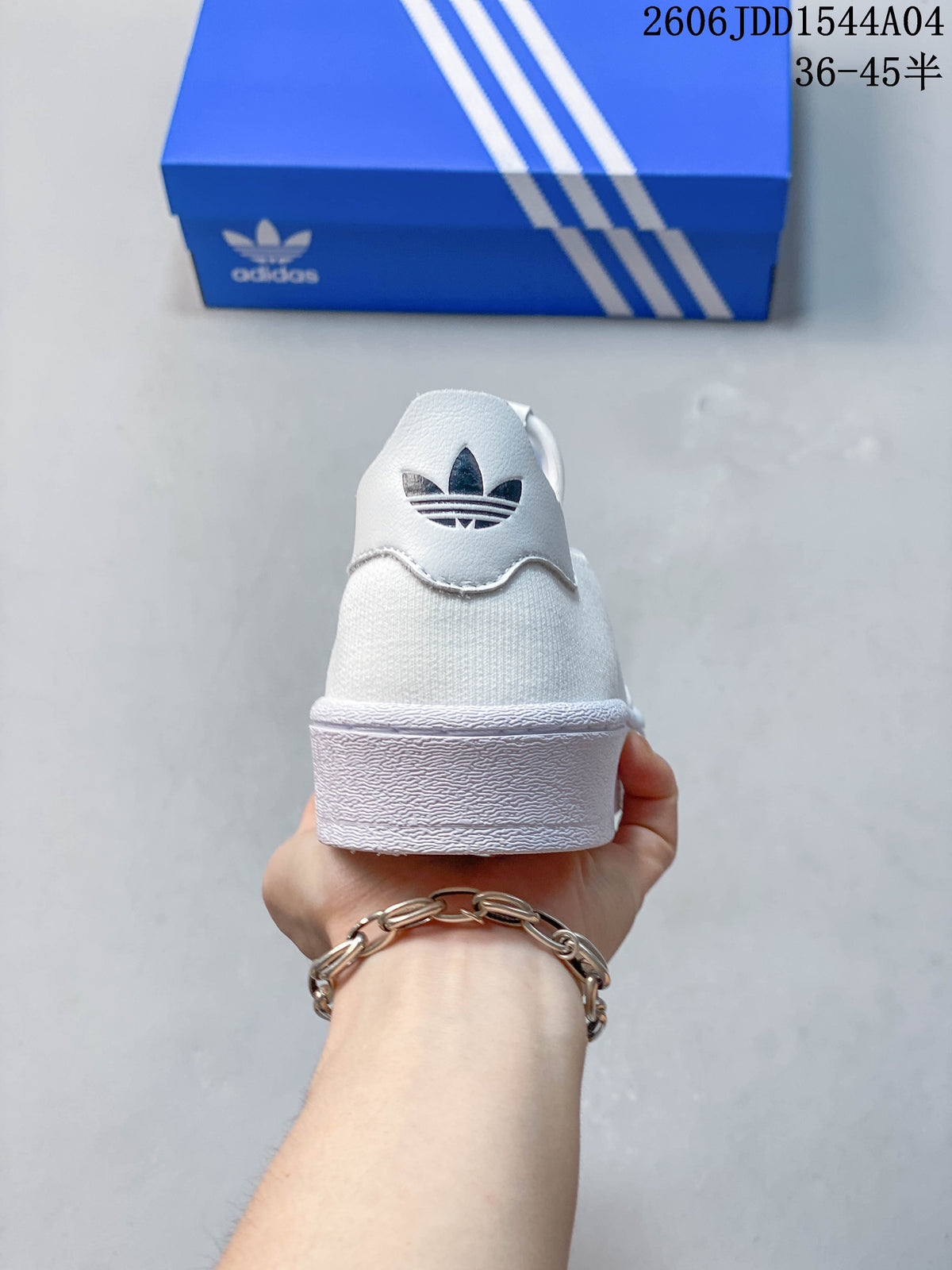 Rear view of the white slip-on sneaker with a trefoil logo detail.