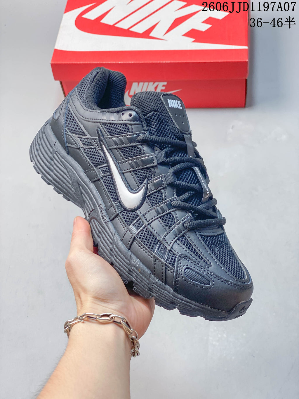 Angled view of the dark gray sneaker with layered upper details