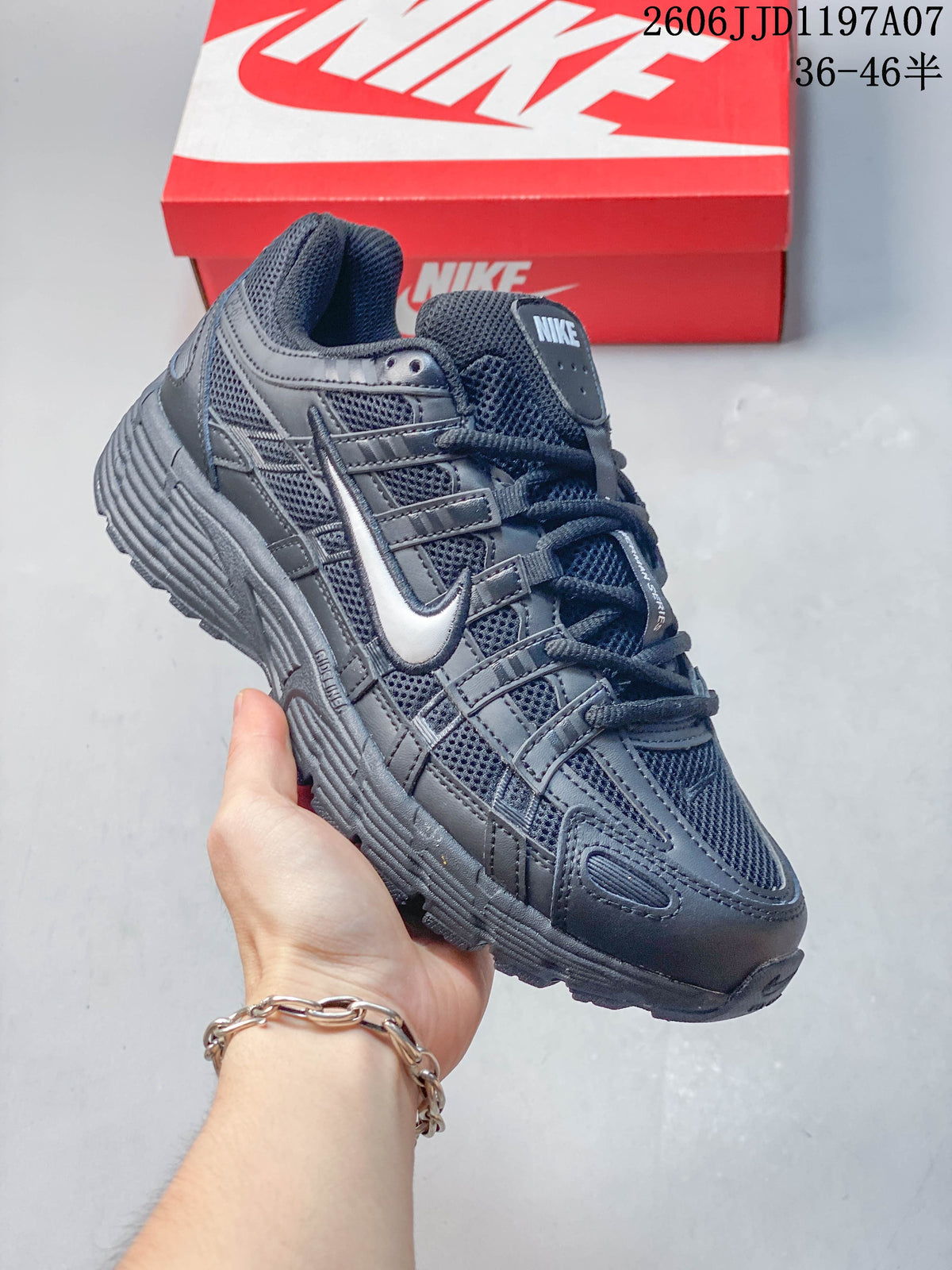 Angled view of the dark gray sneaker with layered upper details