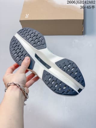 Underside view showing the patterned dark rubber outsole and sculpted white midsole.