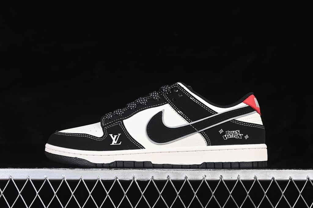 Side view of black and white Nike SB Dunk Low sneakers with red heel accents