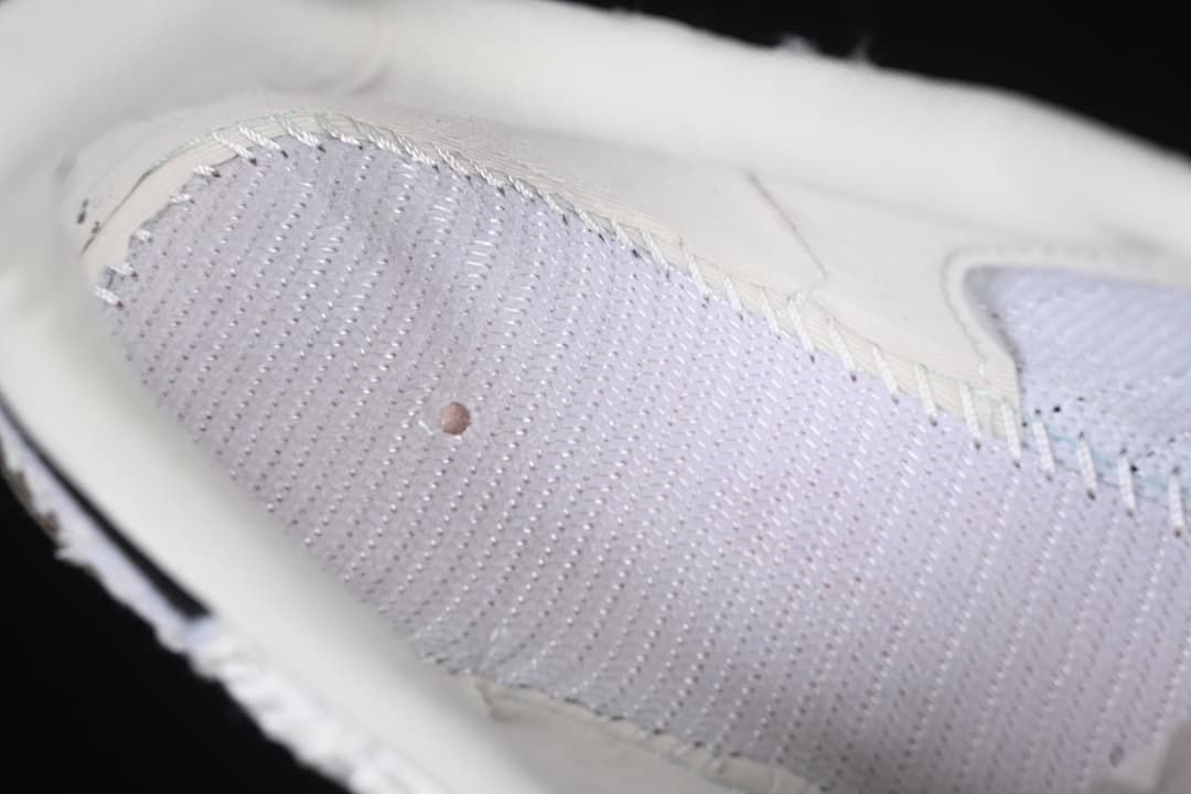 Close-up of the textured white upper and stitched detailing