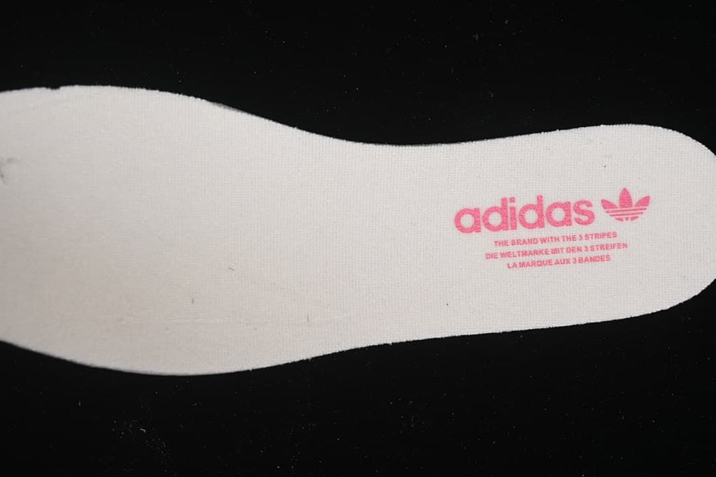 Close-up of a white insole with adidas branding.
