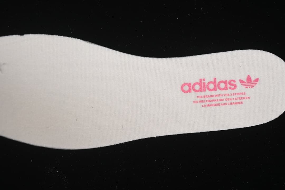 Close-up of a white insole with adidas branding.