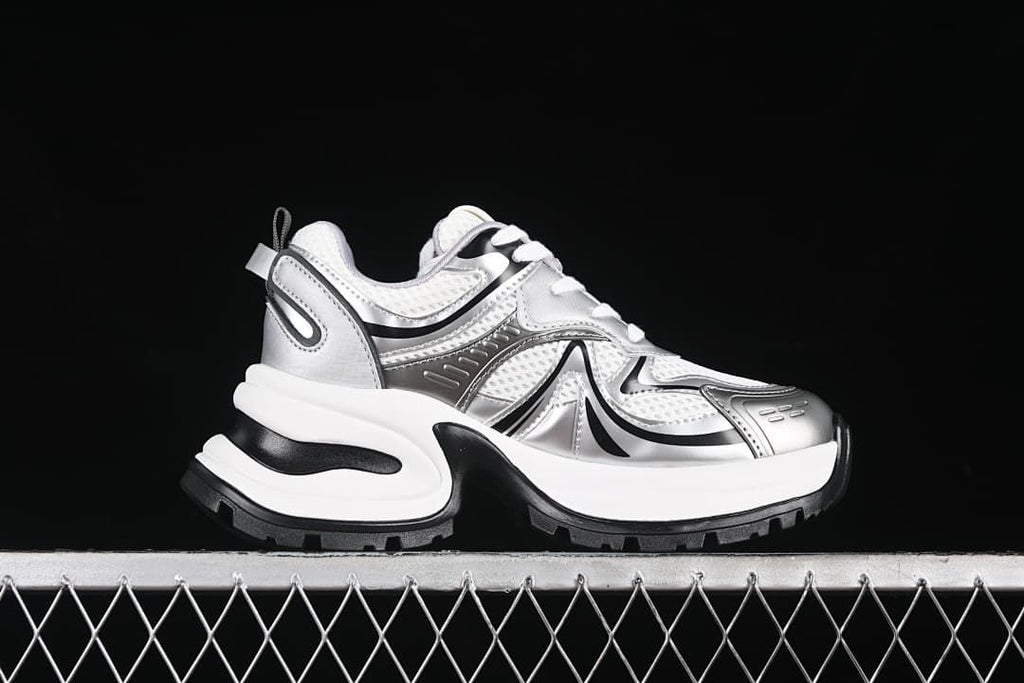 Side profile of one silver, white, and black sneaker
